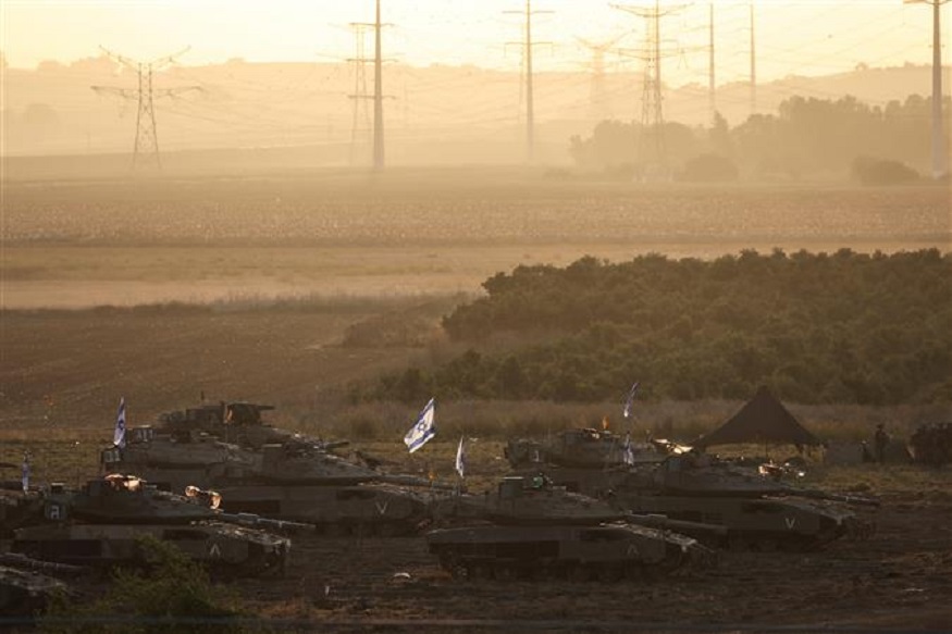 A formation of Israeli tanks and other military is positioned near Israel's border with the Gaza Strip, in southern Israel on October 19, 2023. Reuters

